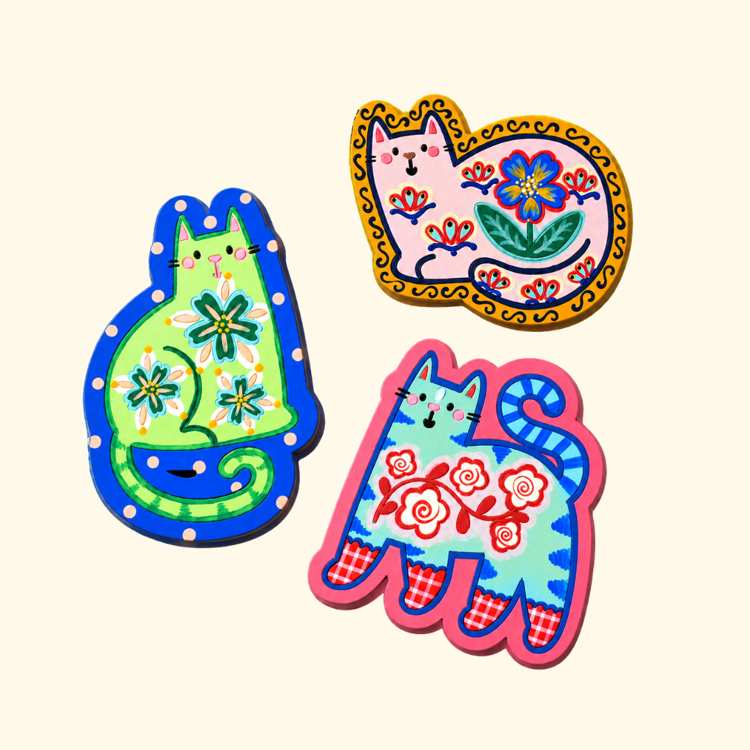 Set of three finished folk cat magnets decorated with colourful hand-painted patterns.