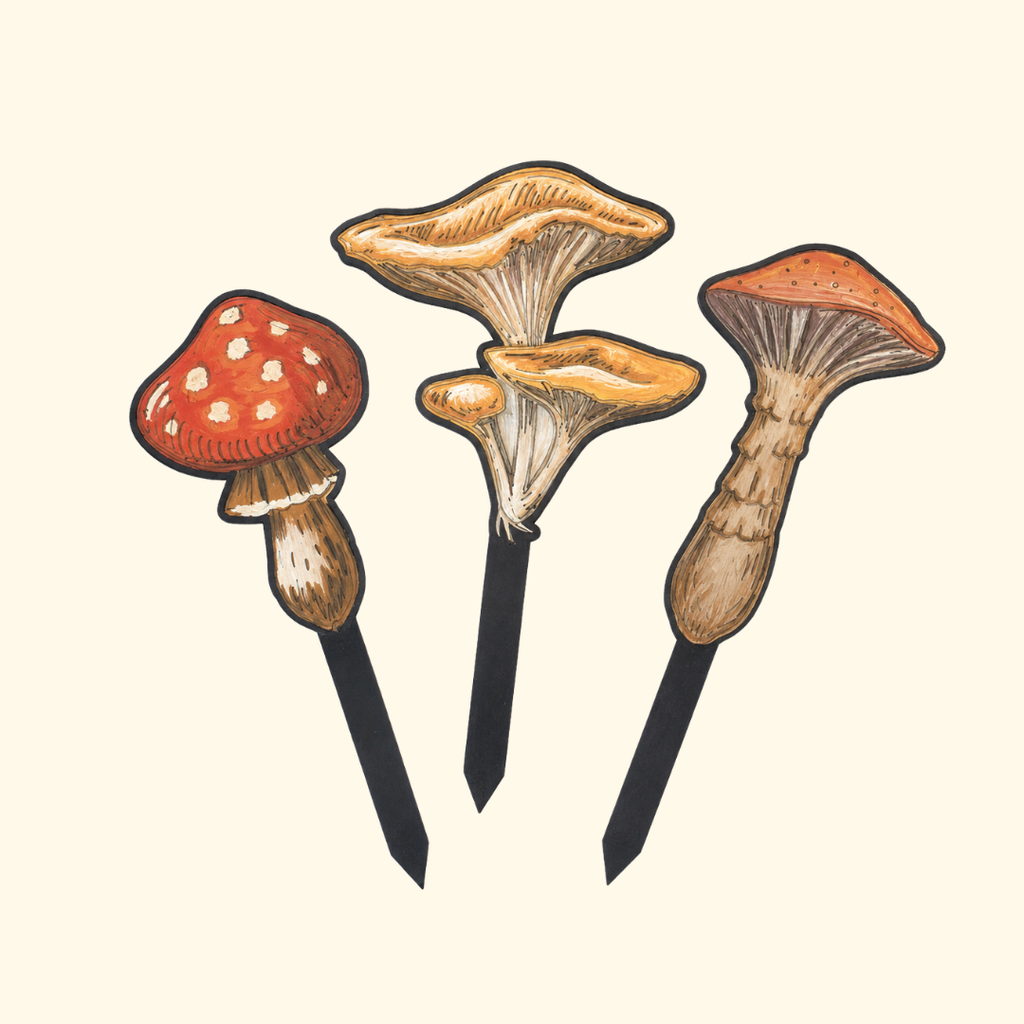 Set of three finished mushroom plant stakes painted in earthy red, orange and brown acrylic paints.
