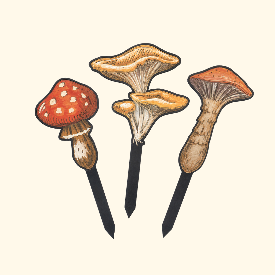 Set of three finished mushroom plant stakes painted in earthy red, orange and brown acrylic paints.