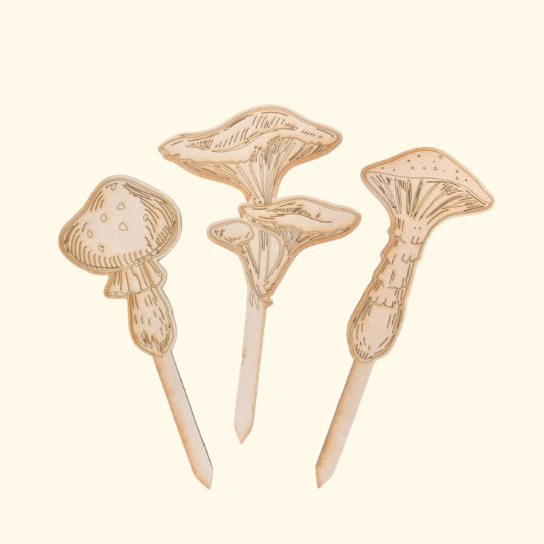 Set of three unpainted laser-cut wooden mushroom stakes included in the paint-your-own plant stakes kit.