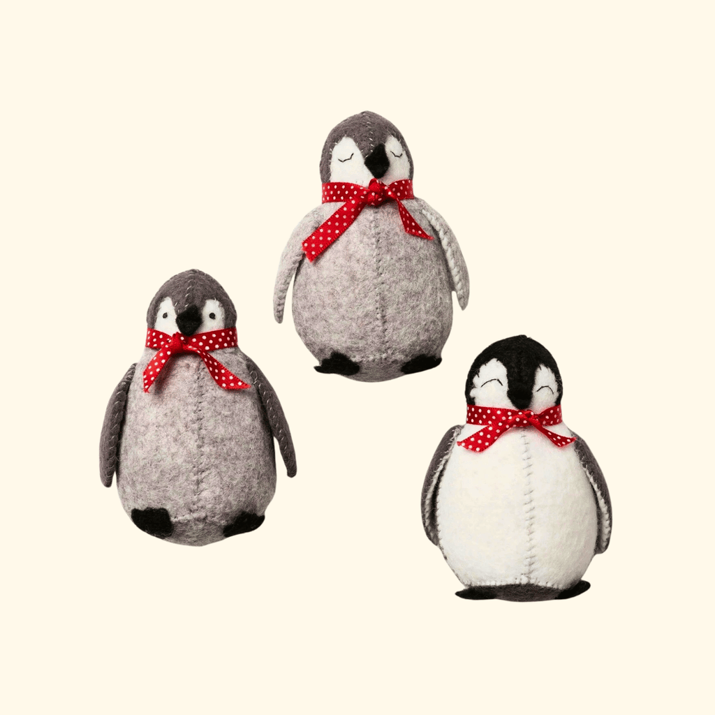 Completed Set of 3 Penguin Felt Craft Kit featuring three handmade felt penguins with red scarves.