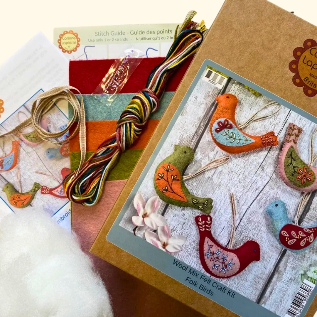 Contents of the Set Of 5 Folk Birds Felt Craft Kit by Corinne Lapierre including felt pieces, threads, stuffing, needle and instructions.