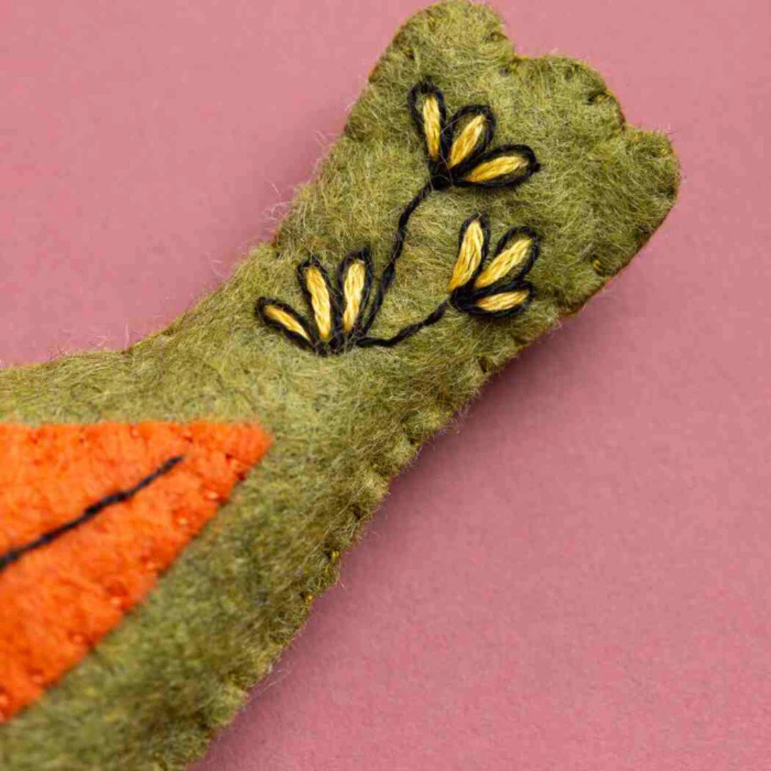 Close up of felt applique and hand stitched detailing on a bird ornament from the Set Of 5 Folk Birds Felt Craft Kit by Corinne Lapierre.
