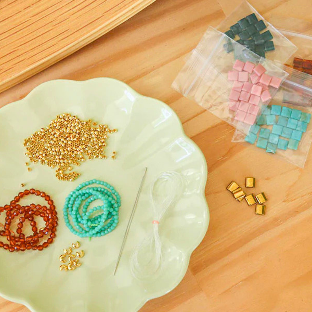 Contents of the La Petite Epicerie Set Of 7 Bracelet Making Kit before assembly.