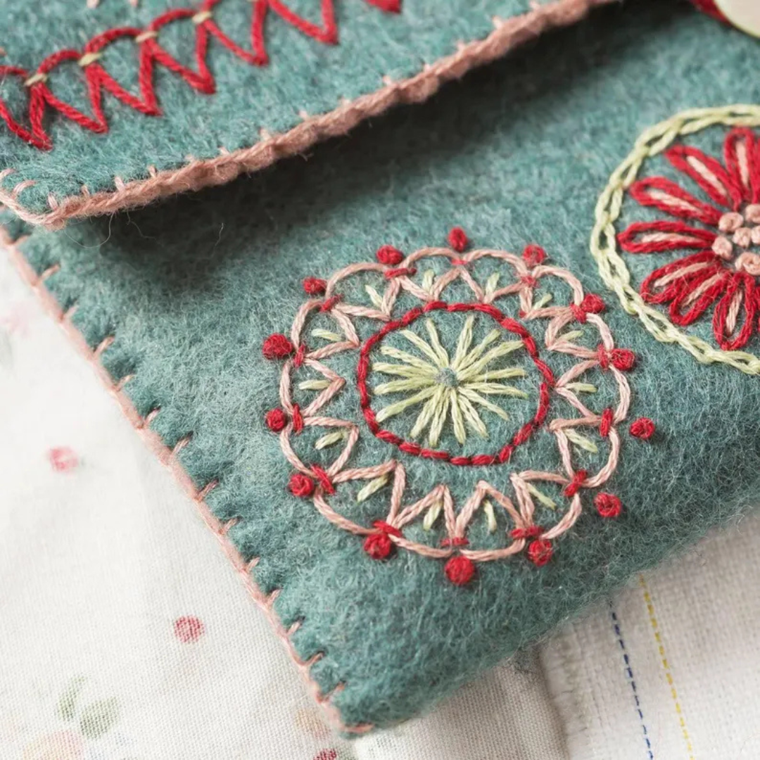 Close up of embroidered floral detail on the felt sewing pouch with decorative stitching