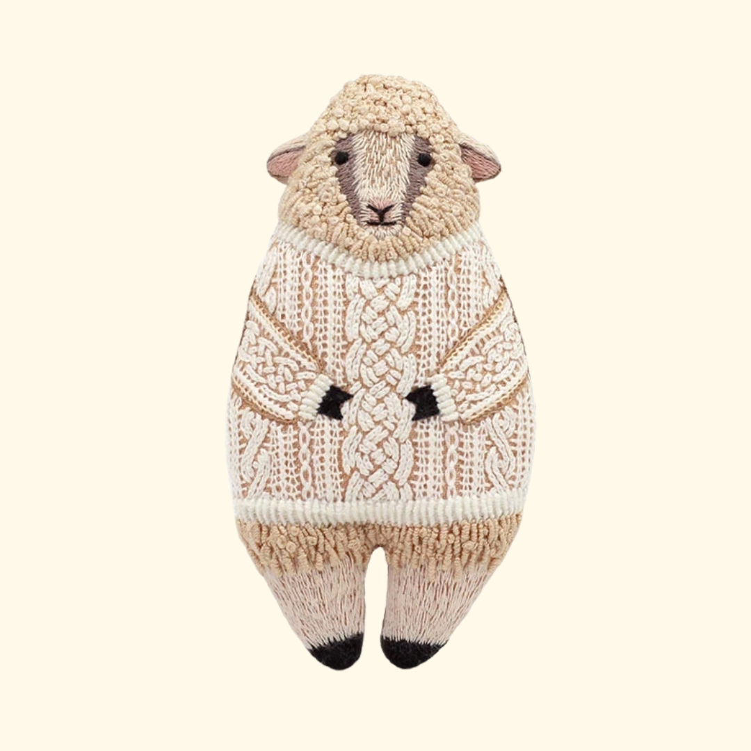 Finished Sheep Embroidery Kit by Kiriki Press, featuring a hand embroidered cream sheep doll with stitched details.