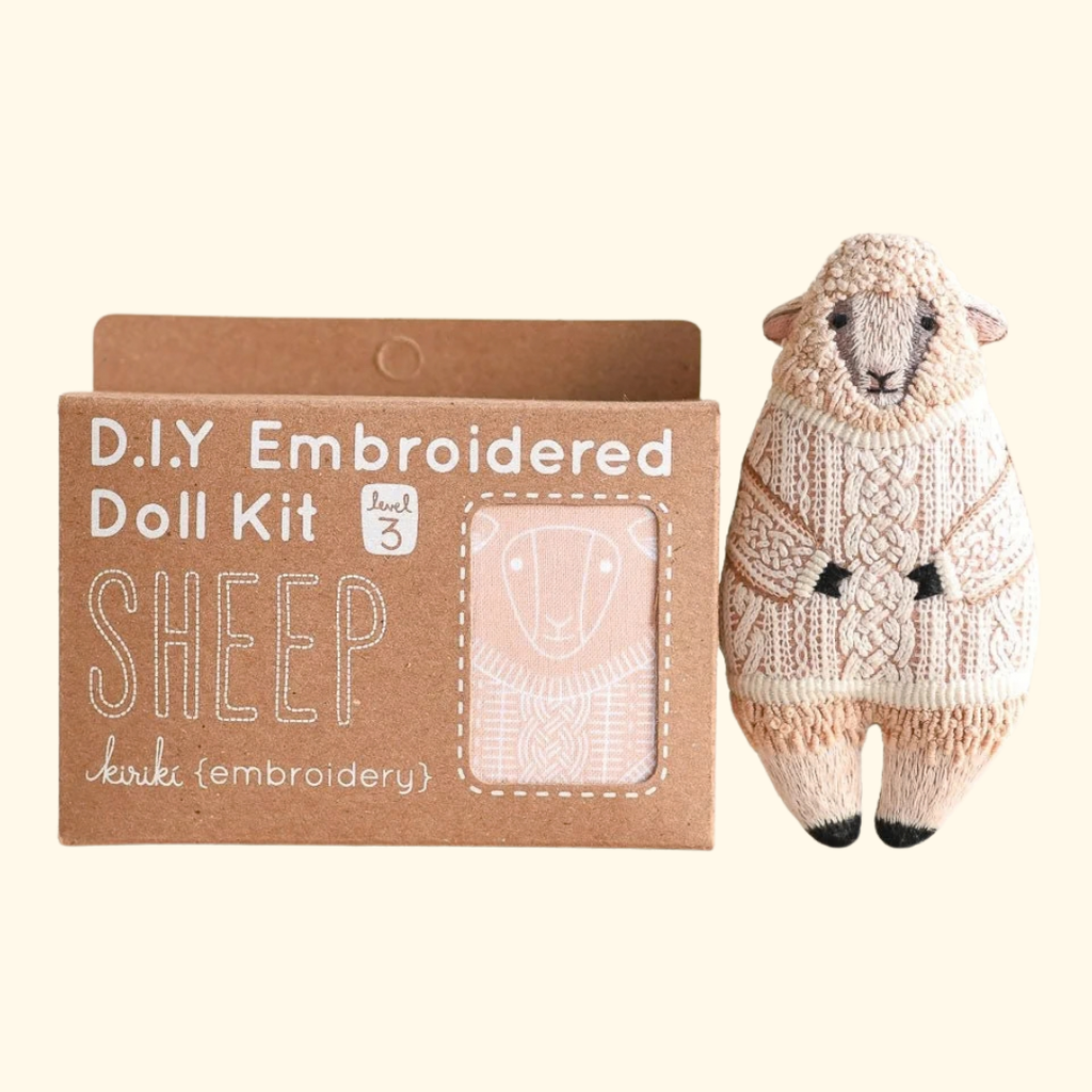 Kiriki Press Sheep Embroidery Kit shown with the finished embroidered sheep doll and DIY kit packaging.