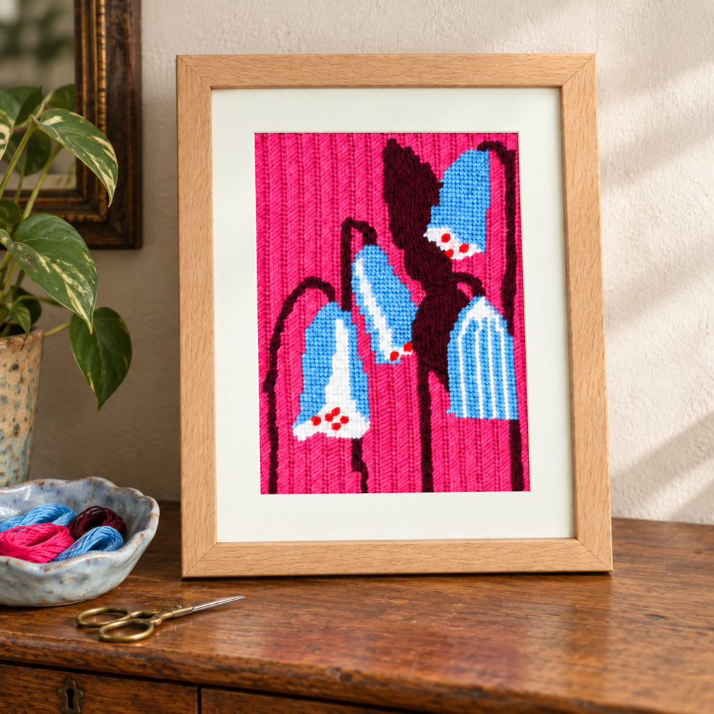 Finished Silky Leather needlepoint portrait framed and displayed as colourful wall art
