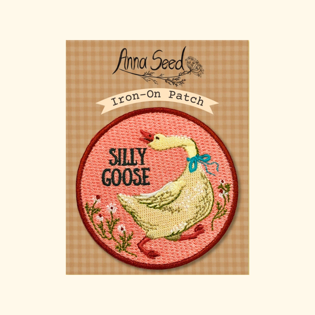 Packaged Silly Goose iron on embroidered patch by Anna Seed Art displayed on its backing card.