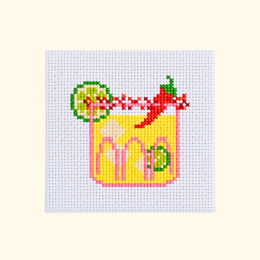 Completed spicy margarita cross stitch design with a lime wheel and red chilli garnish.