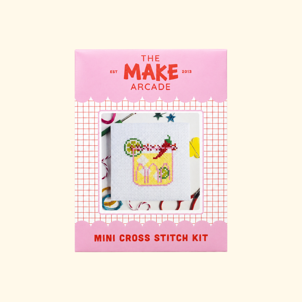 The Make Arcade Spicy Marg Mini Cross Stitch Kit in pink recyclable packaging.