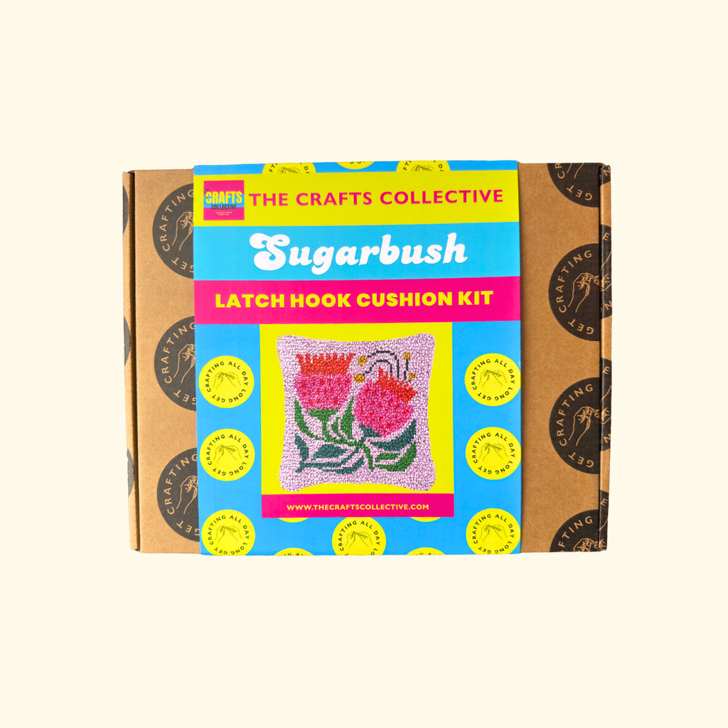 Sugarbush Latch Hook Cushion Kit by The Crafts Collective in colourful gift box packaging.