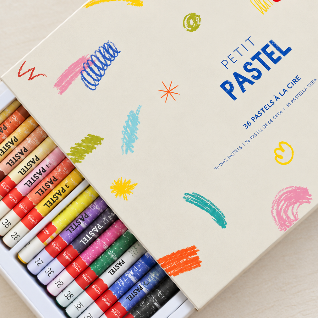 Box of colourful wax pastels arranged beside a practice sheet with pastel colour samples for the Sugiton Cove Pastels By Numbers Kit.