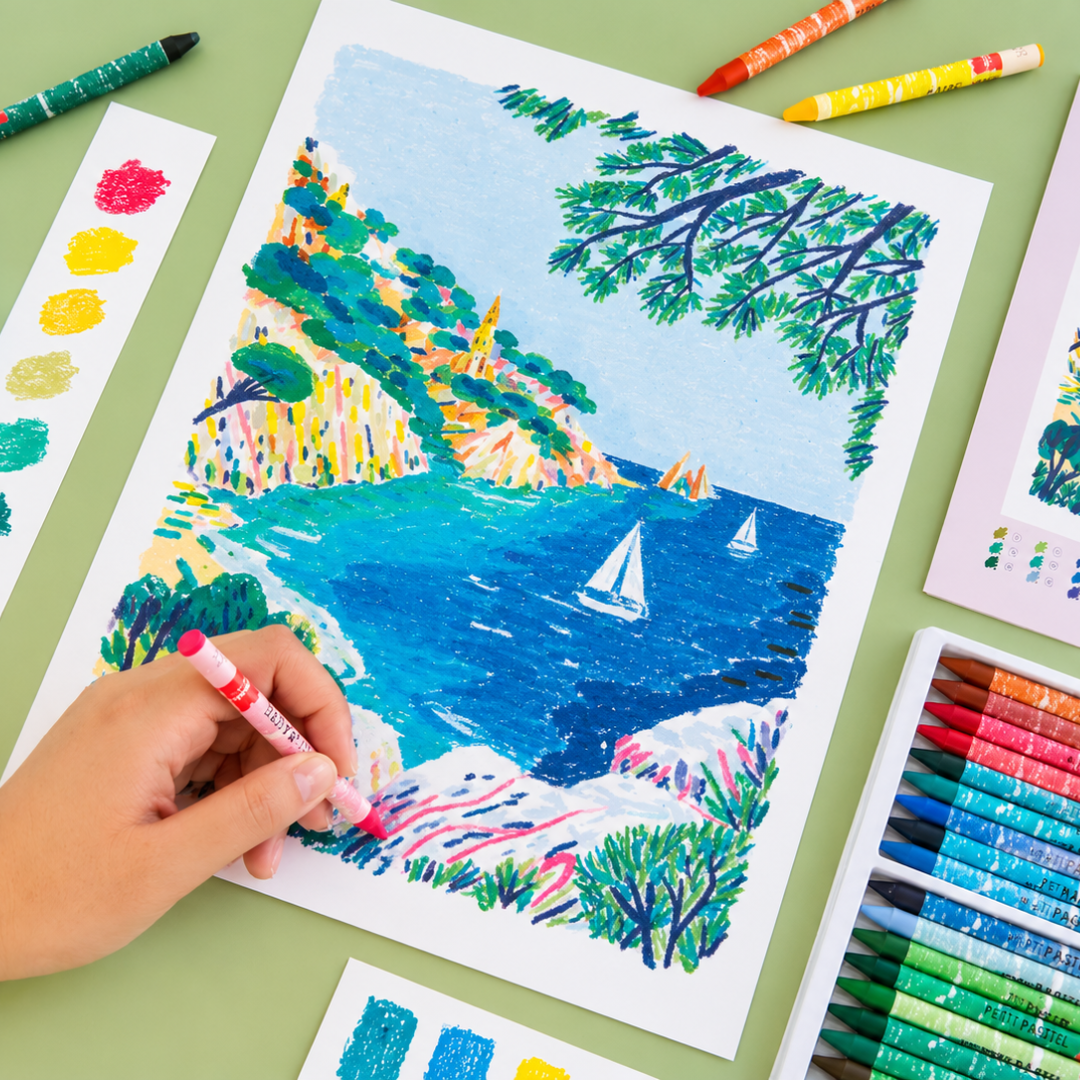 Close-up of the Sugiton Cove Pastels By Numbers artwork being coloured with wax pastels, featuring brilliant blue waters, coastal cliffs and green foliage.