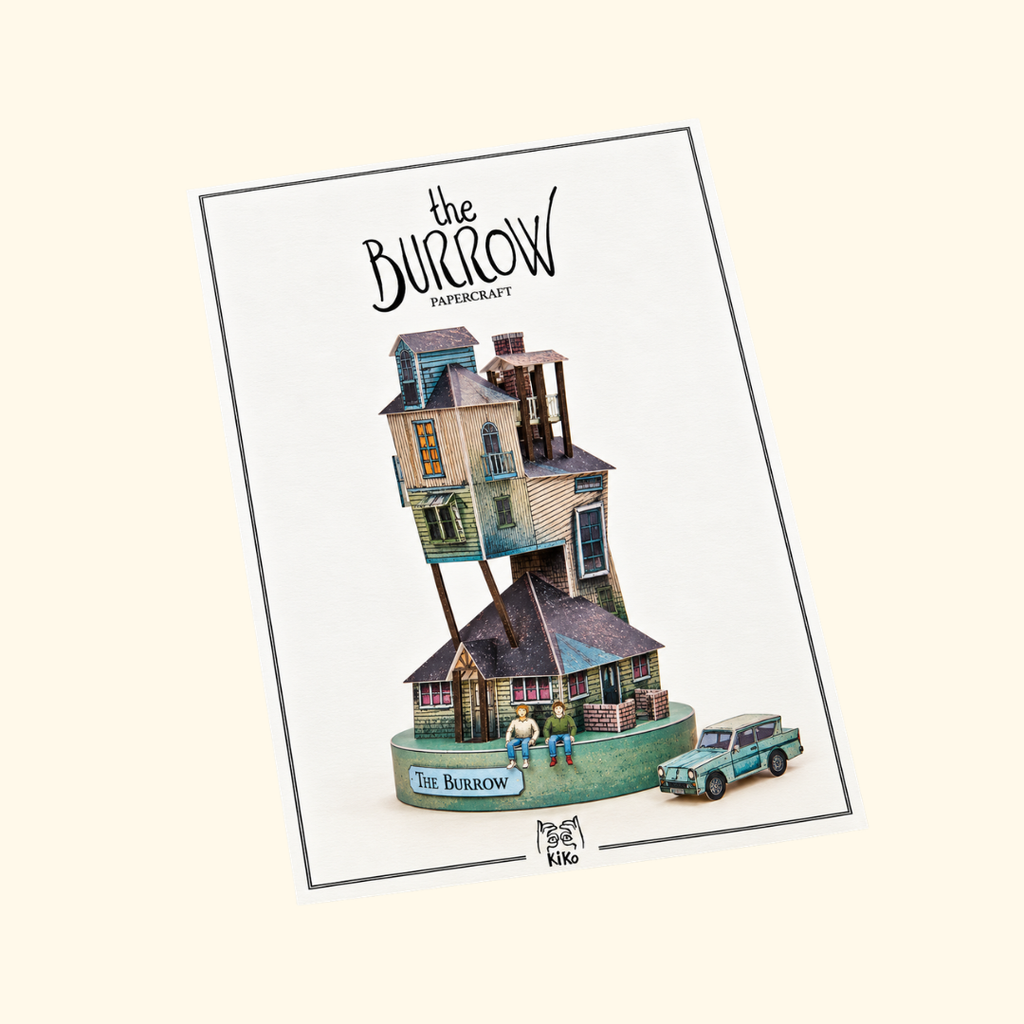 The Burrow Paper Model Kit by Kiko Ilustrador in its illustrated packaging, featuring the iconic Weasley family house from the Harry Potter series.