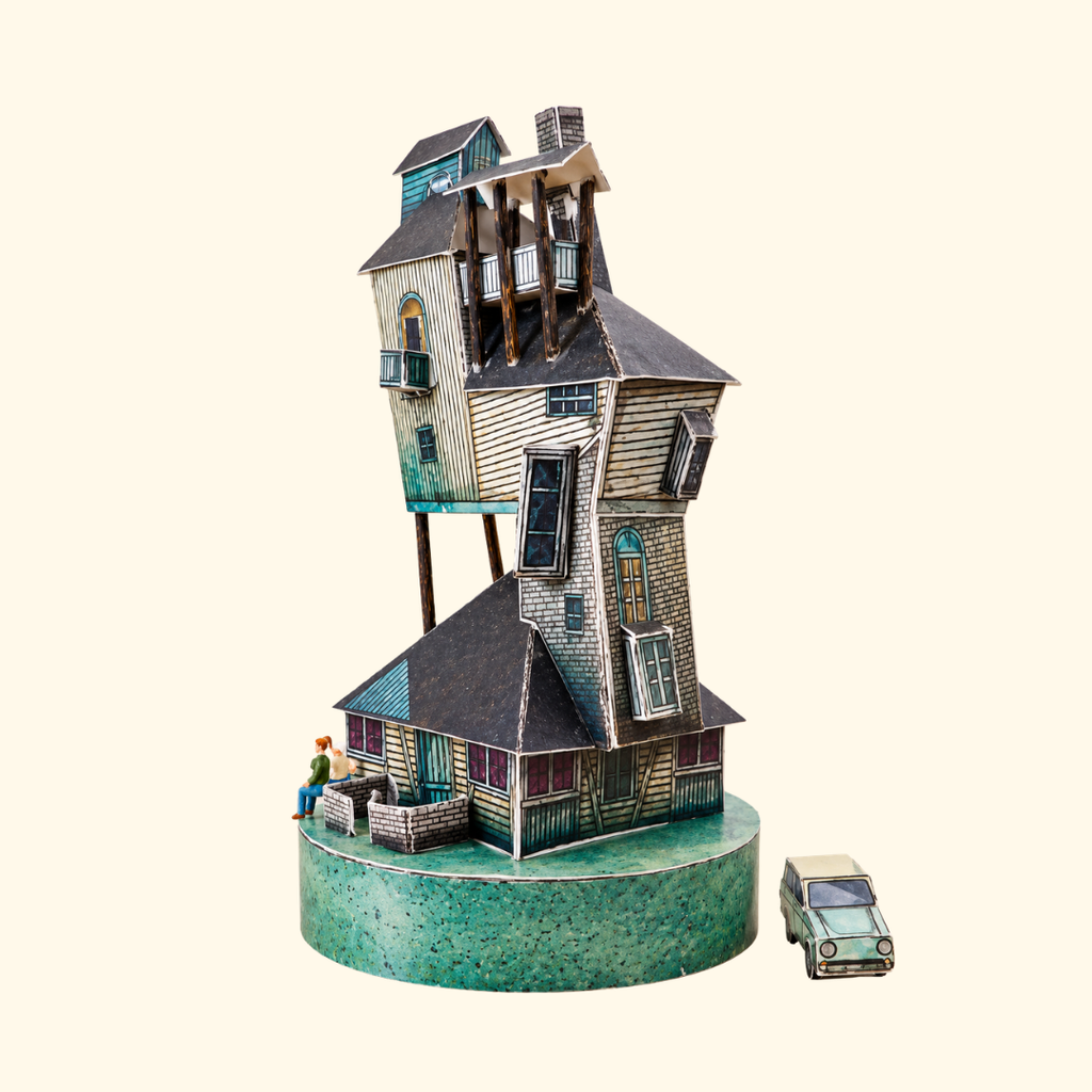 Rear view of The Burrow paper craft model showing the tall, crooked structure of Arthur and Molly Weasley's magical family home from the Harry Potter films.