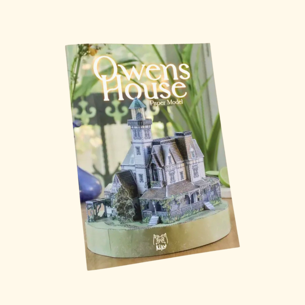 The Owens House Paper Model Kit by Kiko Ilustrador in its illustrated packaging, featuring the iconic Victorian house from Practical Magic.