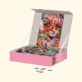 Open box of The Lovers 1000 piece puzzle with drawstring puzzle bag and artwork displayed inside the lid.