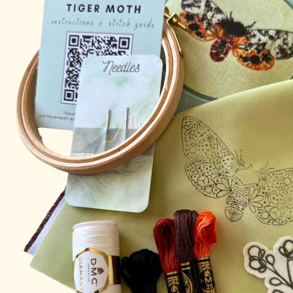 Tiger Moth Mini Embroidery Kit by Nest Embirdery with embroidery threads, wooden hoop and illustrated stitch guide.