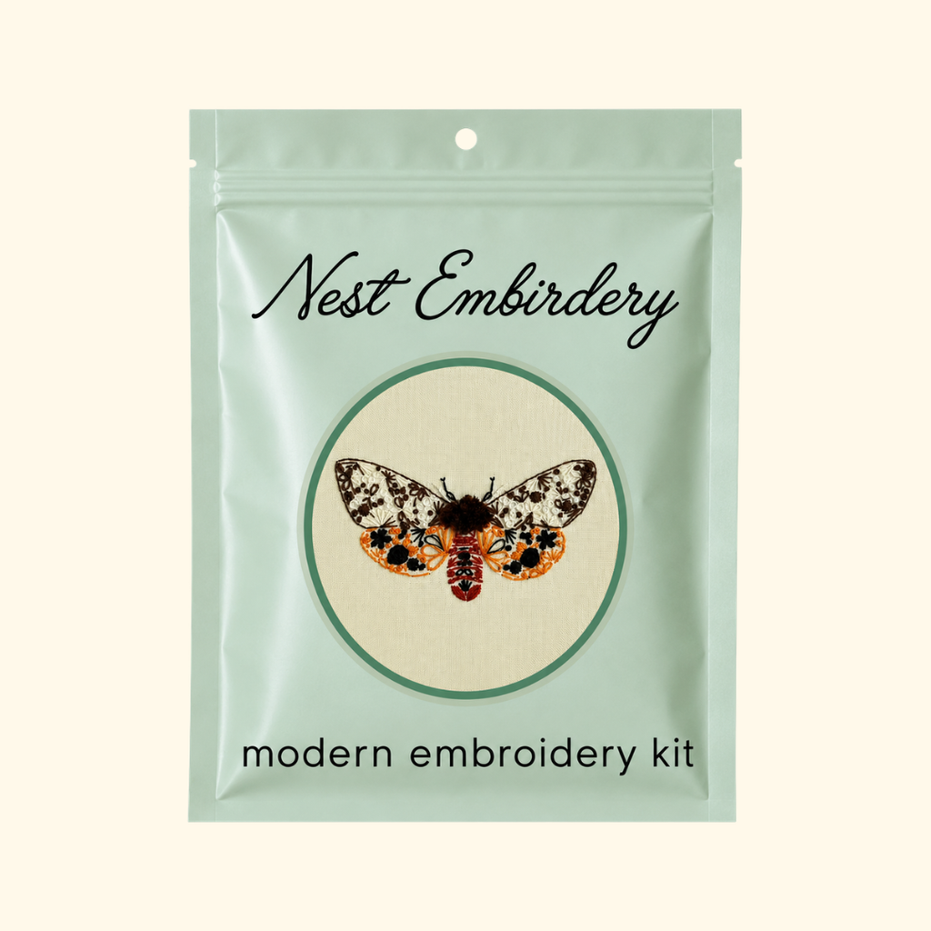 Nest Embirdery Tiger Moth Mini Embroidery Kit packaging featuring the completed insect embroidery design.