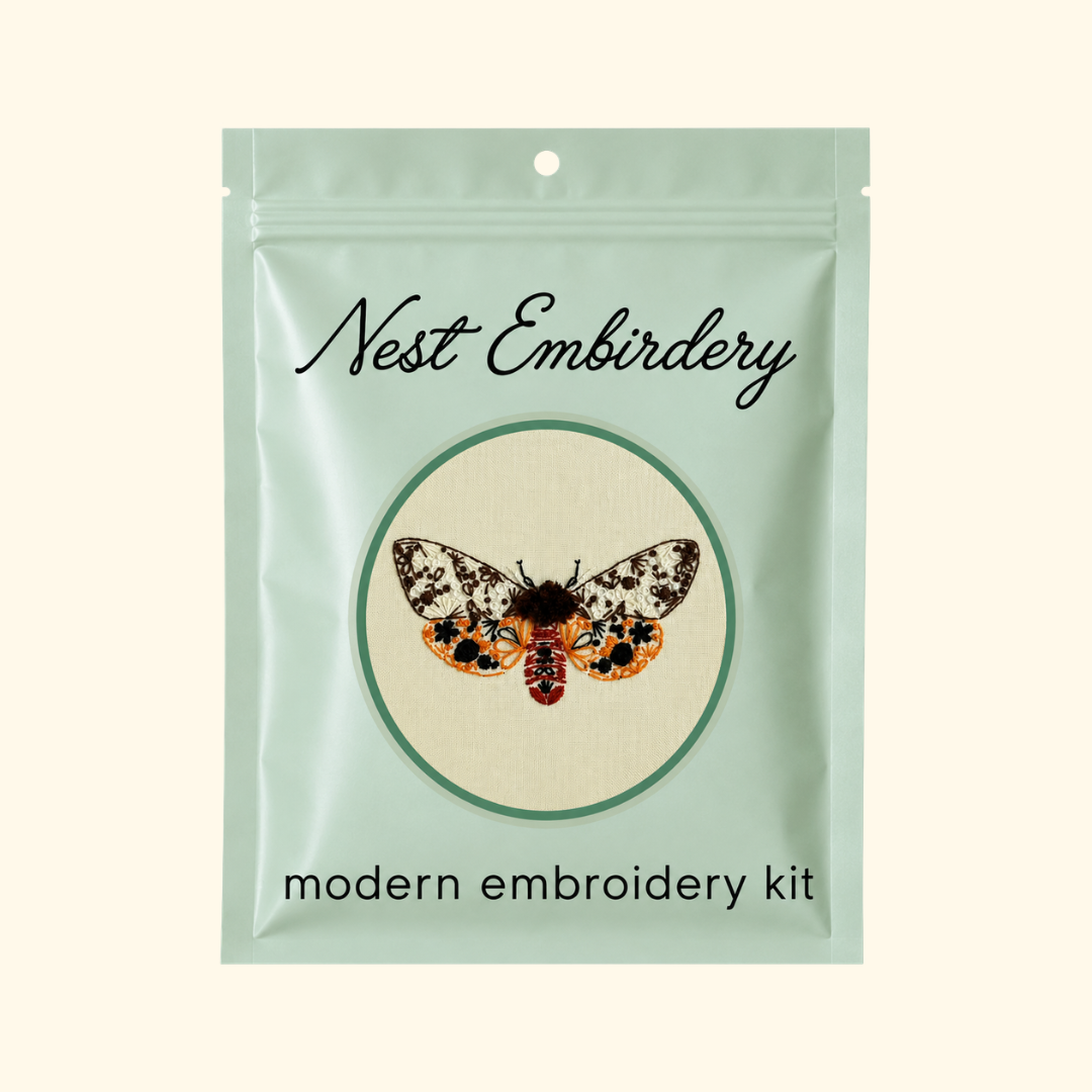 Nest Embirdery Tiger Moth Mini Embroidery Kit packaging featuring the completed insect embroidery design.
