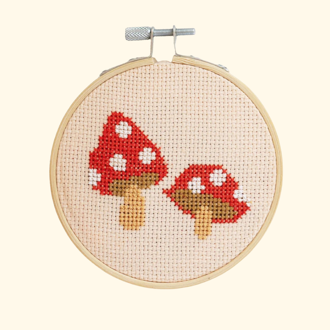 Completed toadstools cross stitch design stitched in a bamboo embroidery hoop by Cotton Clara.