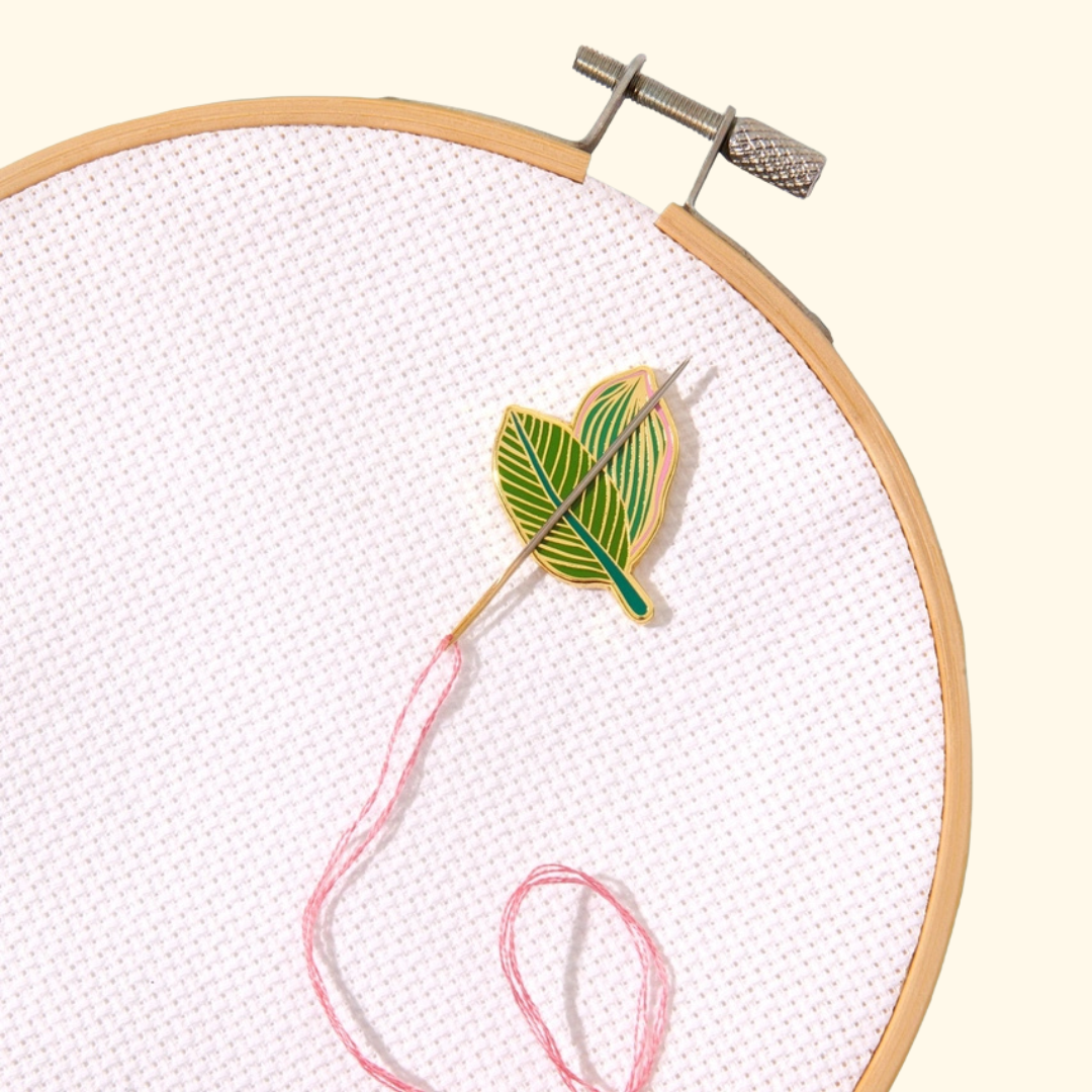 Tropical Leaves Magnetic Needle Minder by SOHMO showing the enamel leaf design, magnet and gold-look backing