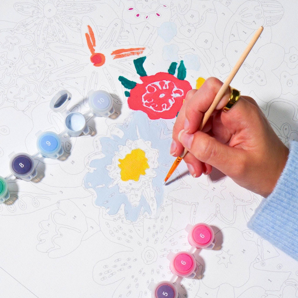 Painting the Wildflowers Paint By Numbers artwork using the included acrylic paints and fine detail brush.