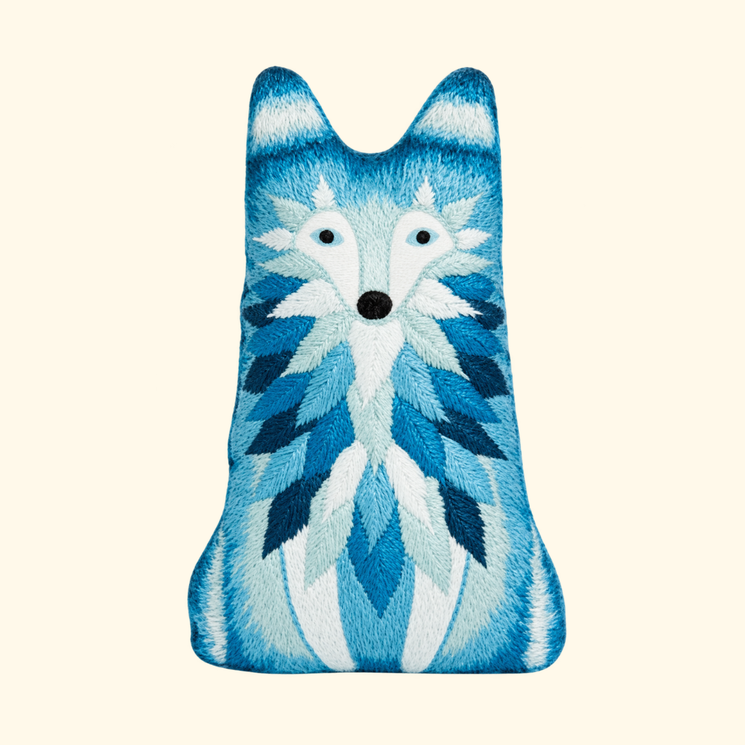 Finished Wolf Embroidery Kit doll in layered shades of blue and white by Kiriki Press.