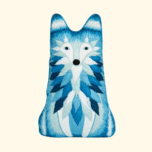 Finished Wolf Embroidery Kit doll in layered shades of blue and white by Kiriki Press.
