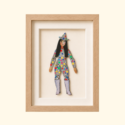 Yayoi Kusama paper puppet by Wini Tapp displayed finished in a wooden frame